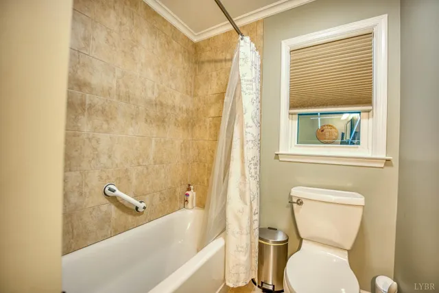 a view of a livingroom with furniture and staircase