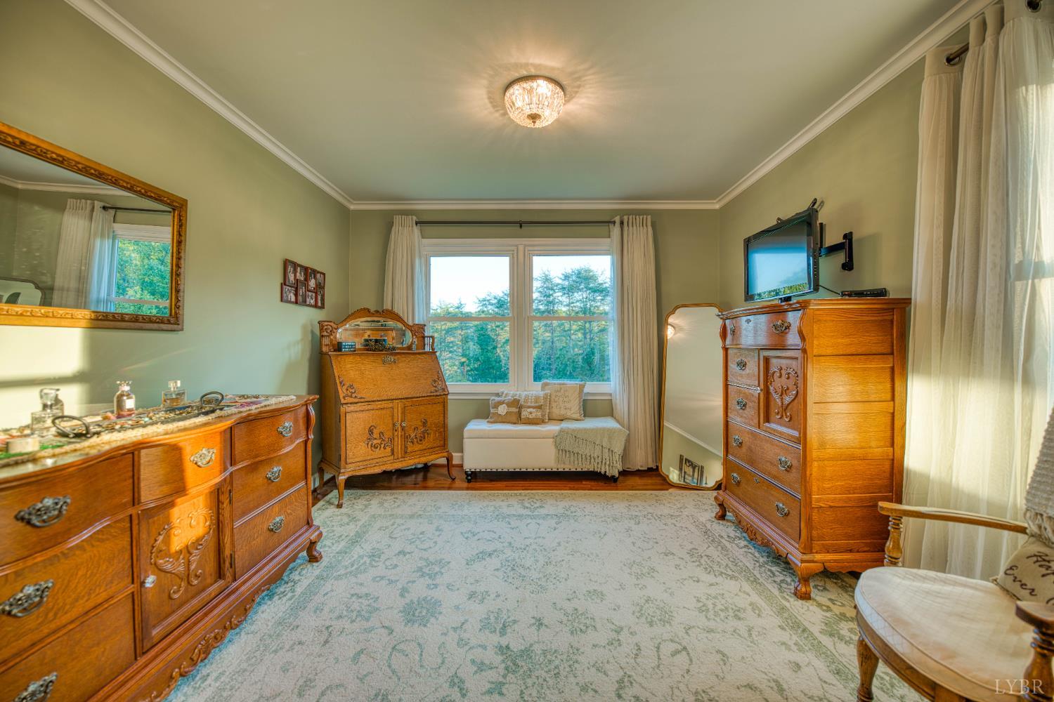 2287 Johnson Creek Road Evington, VA 24550 - Photo 25 of 70 a bedroom with furniture and a flat screen tv
