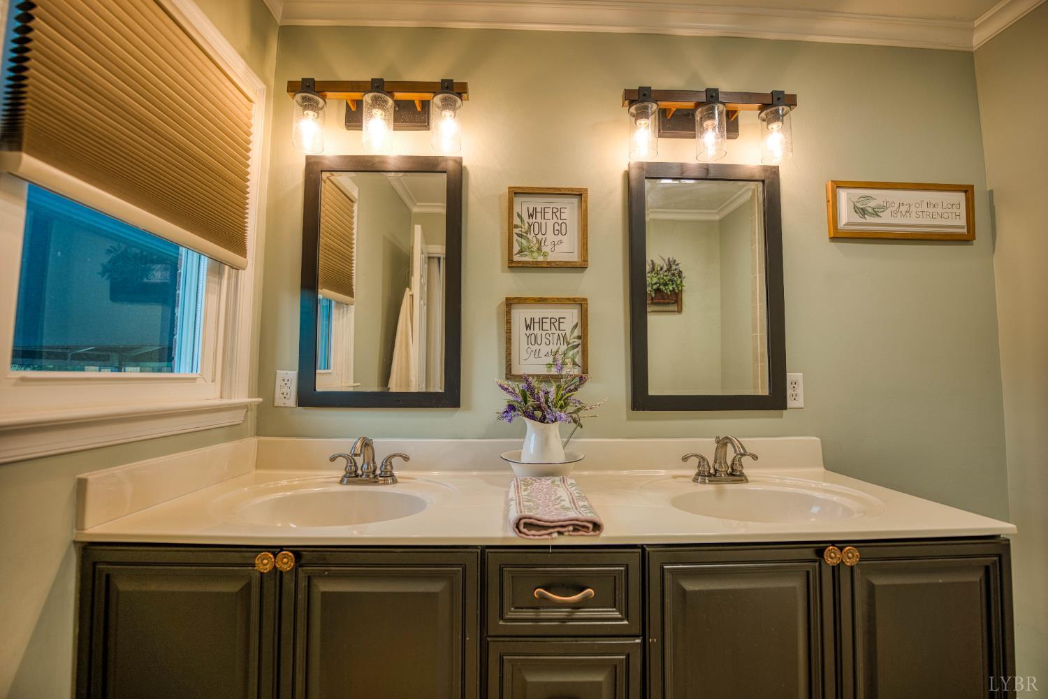 2287 Johnson Creek Road Evington, VA 24550 - Photo 29 of 70 a bathroom with a double vanity sink and a mirror
