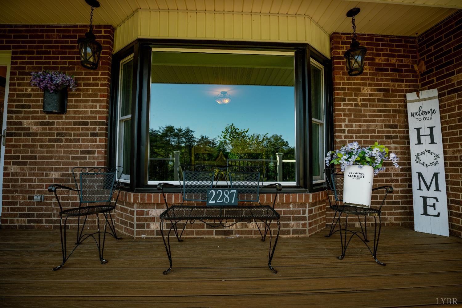 2287 Johnson Creek Road Evington, VA 24550 - Photo 8 of 70 a bench is sitting in front of a building