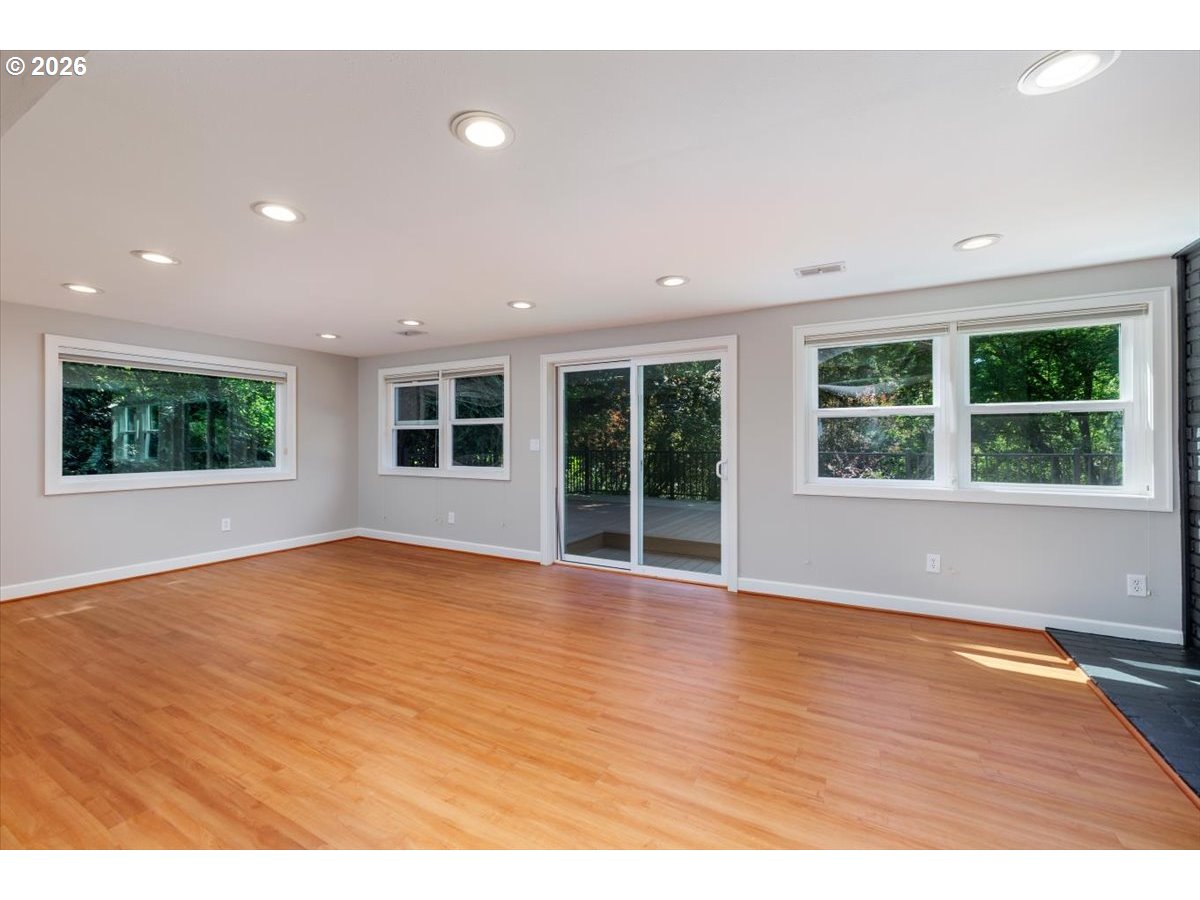 175 Northwest 95th Avenue Portland, OR 97229 - Photo 24 of 46 an empty room with wooden floor and windows