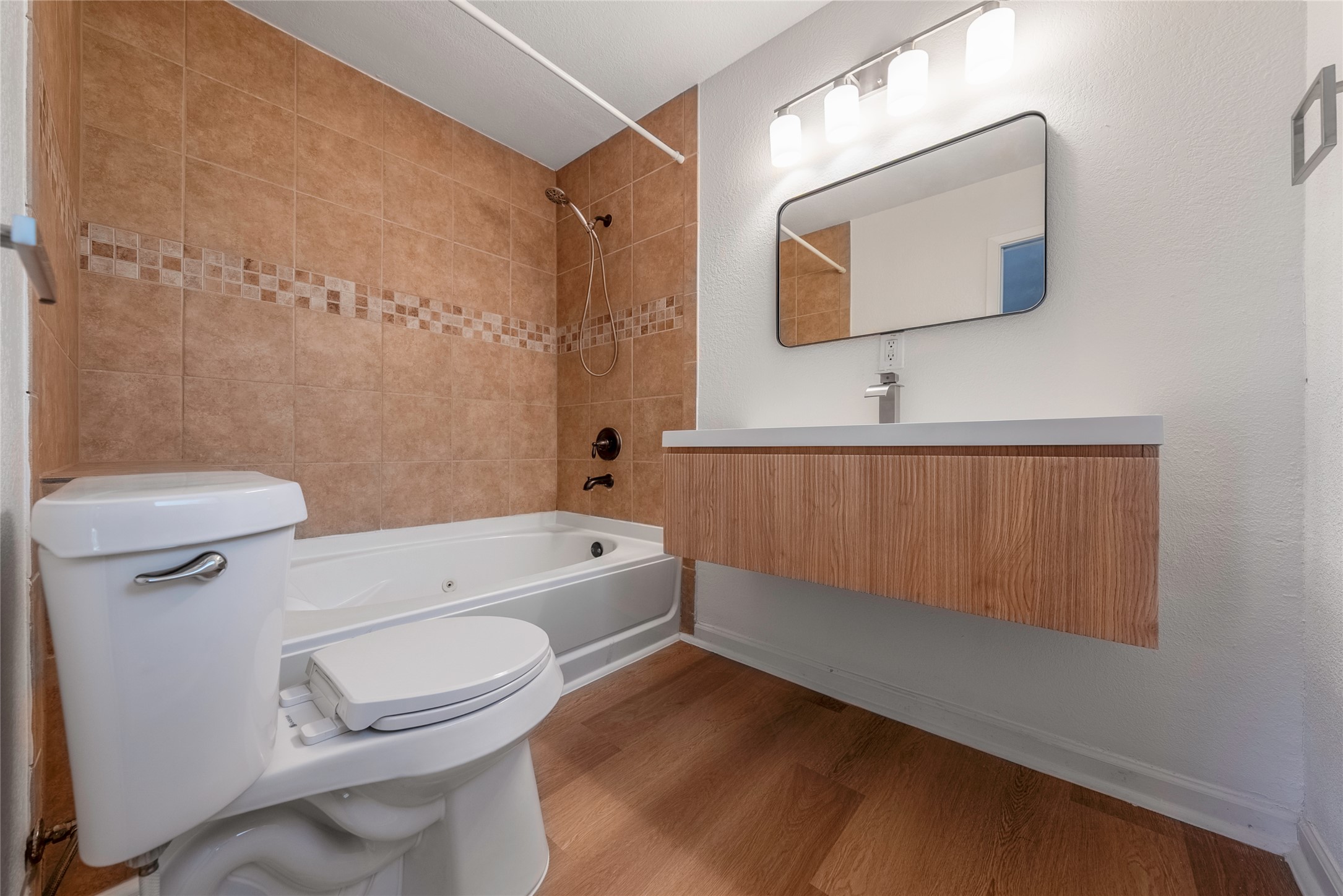 807 Country Club Road Georgetown, TX 78628 - Photo 17 of 28 a bathroom with a toilet a sink a mirror and bathtub