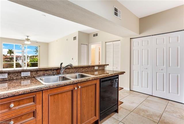 a kitchen with stainless steel appliances granite countertop a sink and a granite counter tops