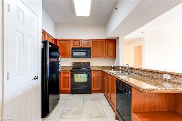 a kitchen with stainless steel appliances granite countertop a refrigerator and a stove