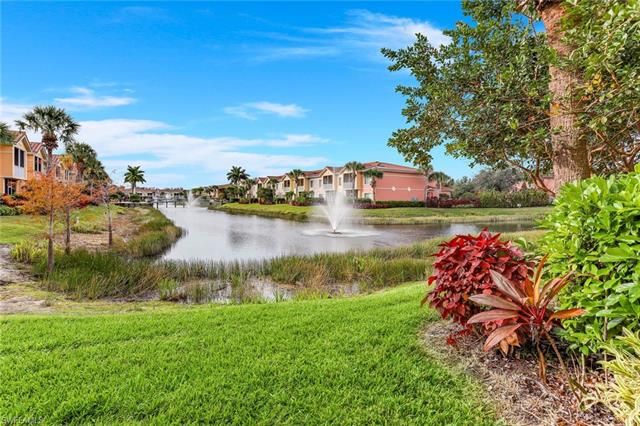 a aerial view of a house with a yard and lake view