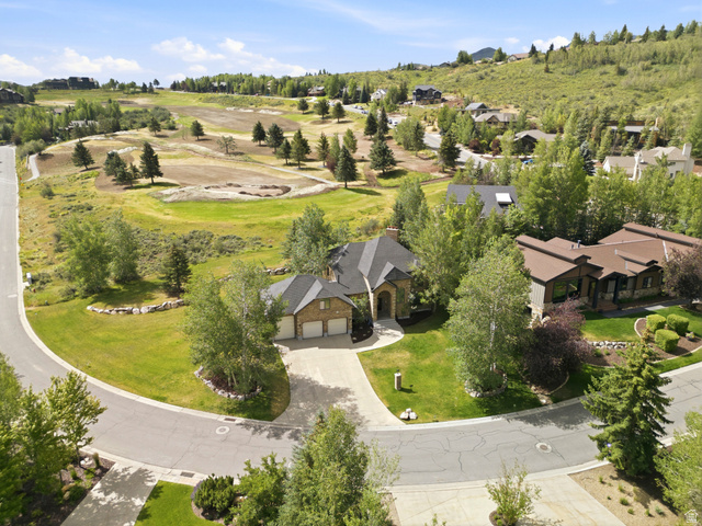 3535 Homestead Road Park City, UT 84098 - Photo 76 of 81 Stone and brick exterior residence featuring a multi-car garage, established landscaping, and a paved driveway within a cul-de-sac