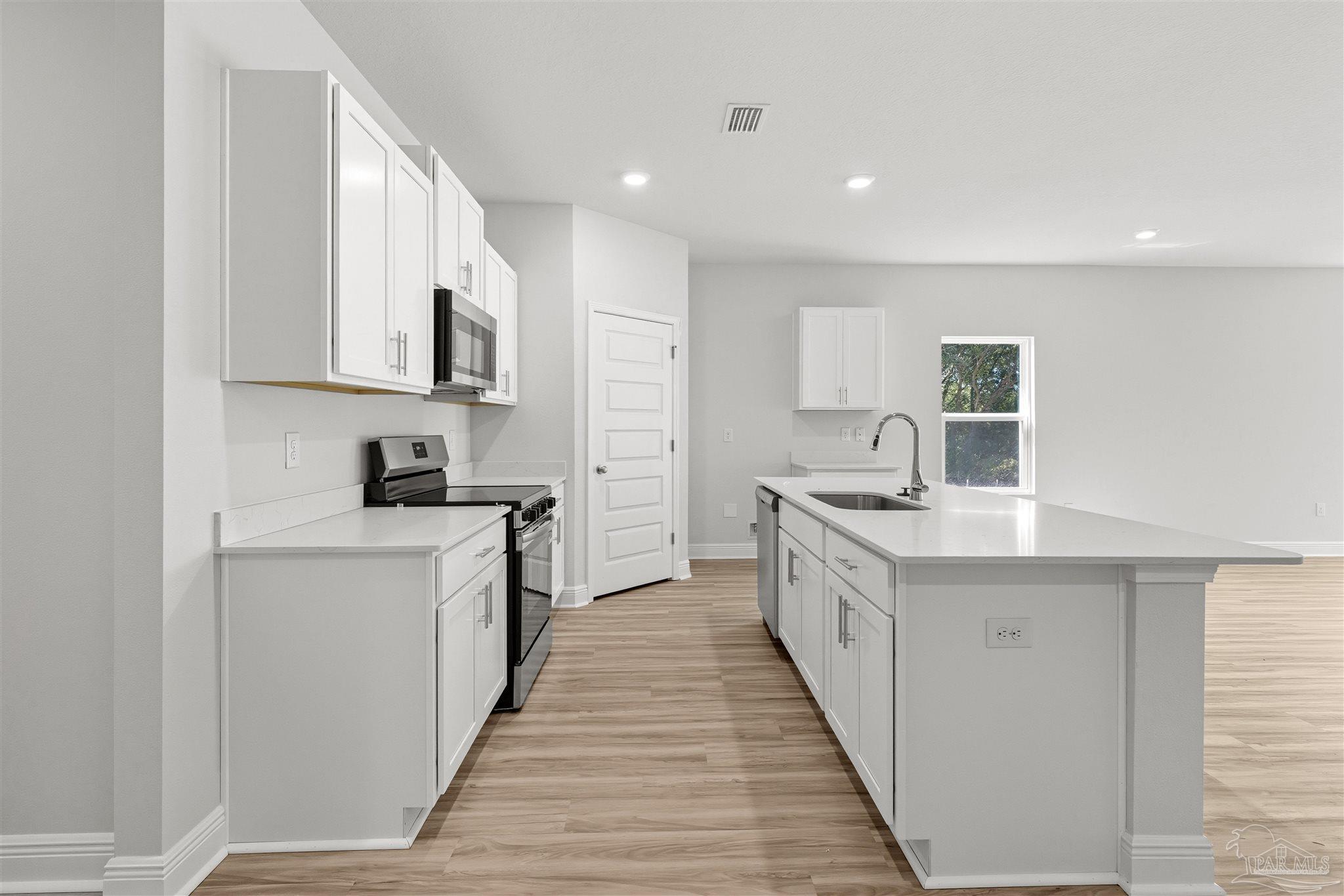 3551 Fallschase Boulevard Pensacola, FL 32526 - Photo 6 of 31 a large kitchen with stainless steel appliances granite countertop a lot of counter space and wooden floors