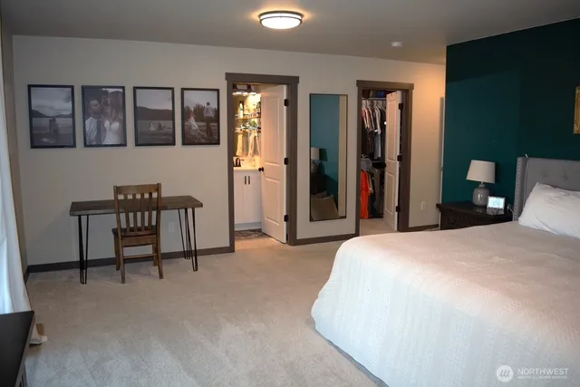 a spacious bedroom with a bed and a table in it