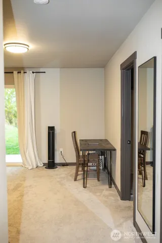 a view of a livingroom with a table and chairs