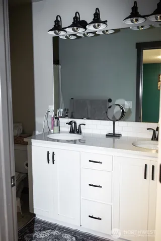 a bathroom with a sink vanity and a mirror