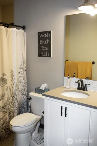 a bathroom with a sink toilet and a mirror