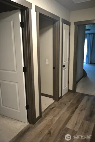 an empty room with wooden floor and closet