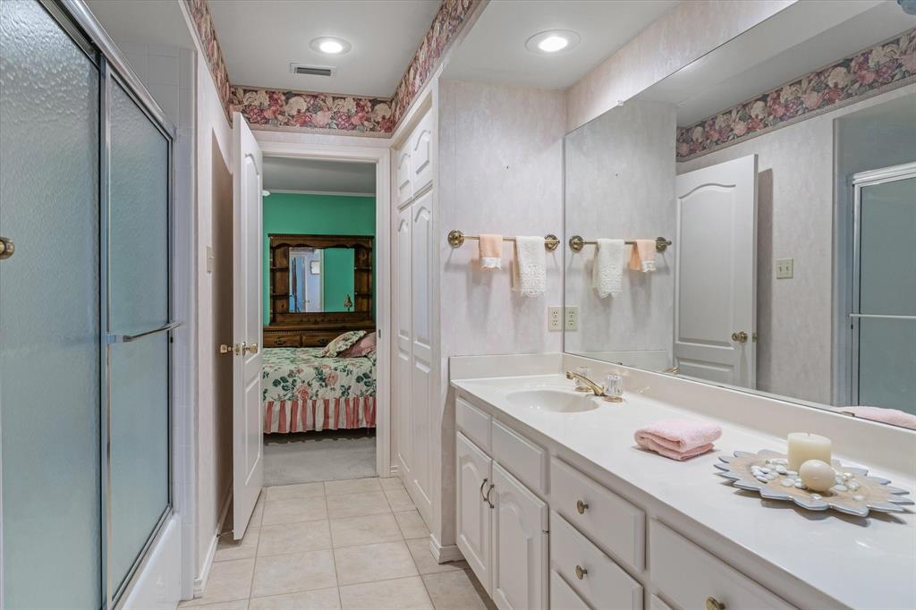 114 Granada Square Canton, TX 75103 - Photo 14 of 23 a spacious bathroom with a granite countertop sink and mirror