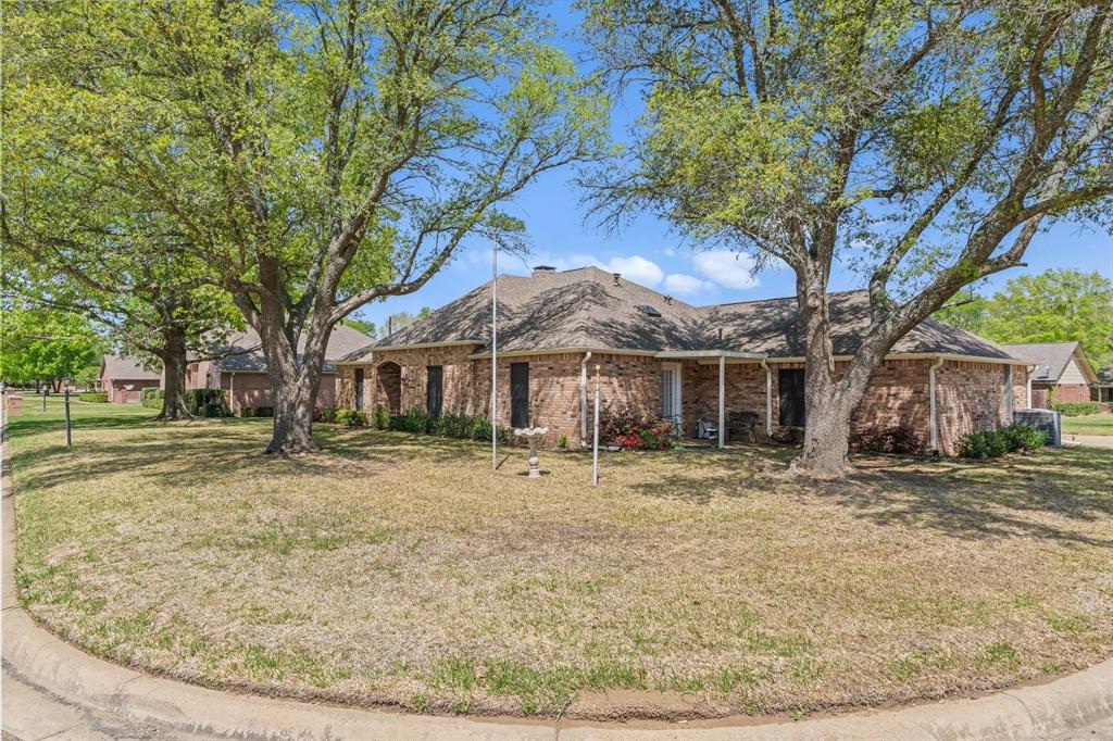 114 Granada Square Canton, TX 75103 - Photo 2 of 23 a backyard of a house with large trees and barbeque oven