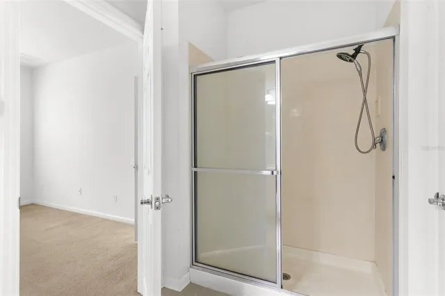 a bathroom that has a glass shower door
