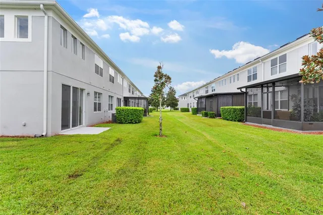 a view of a house with backyard and sitting area