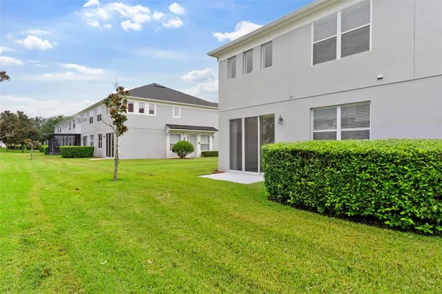 a view of a house with backyard and garden
