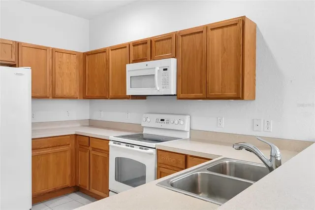 a kitchen that has a sink cabinets counter space and a sink