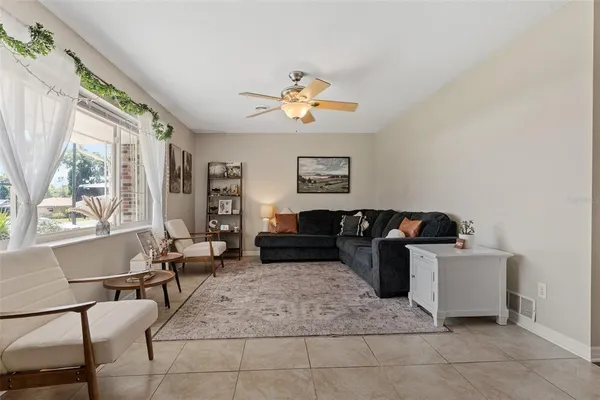 a living room with furniture and a large window