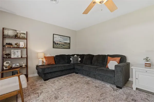 a living room with furniture and painting on the wall