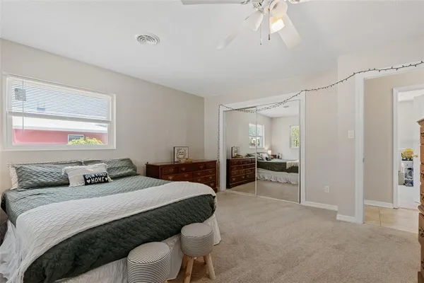 a bedroom with a large bed and a couch