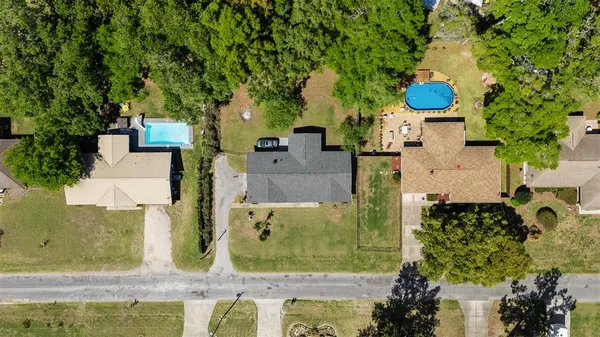 an aerial view of a house with a yard