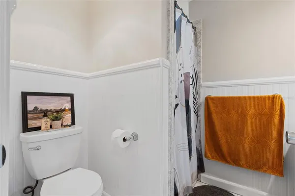 a bathroom with a toilet and a shower