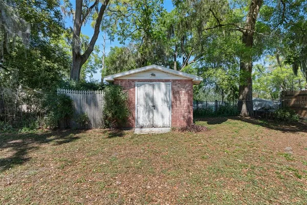 a wooden fence with trees in the background