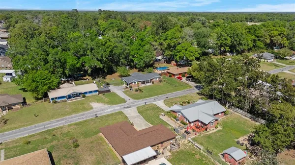 an aerial view of a house with a yard