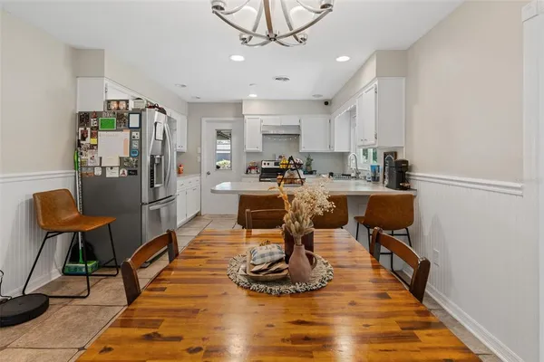 a view of a dining room with furniture a rug and wooden floor
