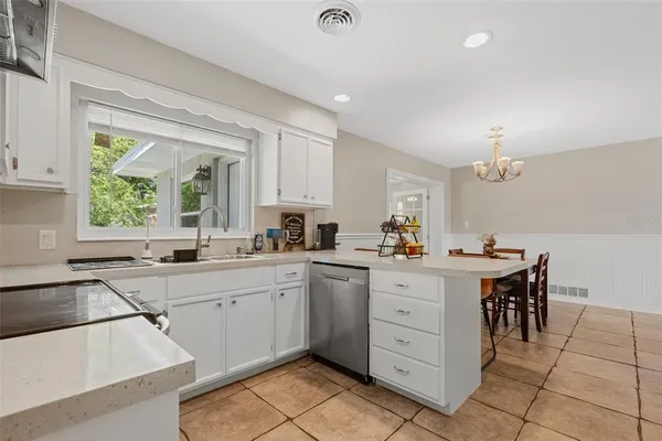 a kitchen with a sink window and cabinets