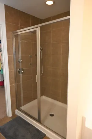 a bathroom with a shower and a sink