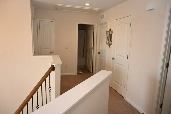 a view of a hallway with closet and front door