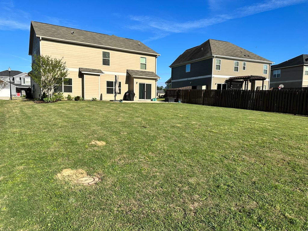 7279 Double Pine Drive Midland, GA 31820 - Photo 22 of 26 a front view of a house with a yard