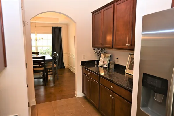 a kitchen with a refrigerator and a stove top oven