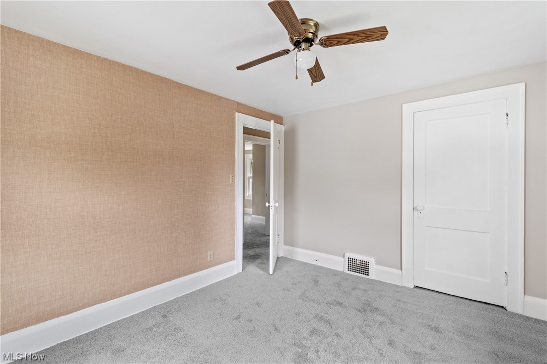 1529 Walnut Road Southwest Massillon, OH 44647 - Photo 15 of 27 Unfurnished room with ceiling fan and light colored carpet