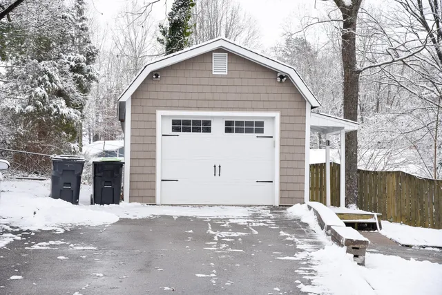 a view of a house with snow on the road