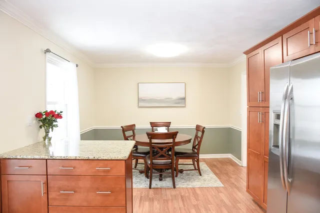 a dining room with furniture and wooden floor