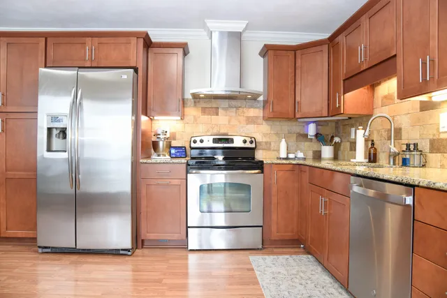a kitchen with granite countertop a refrigerator and a sink