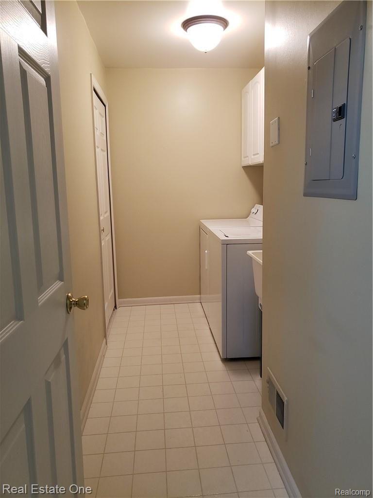1918 Flagstone Circle Rochester, MI 48307 - Photo 15 of 18 Same-floor laundry has bonus closet with hanging space, cabinets, and utility sink.