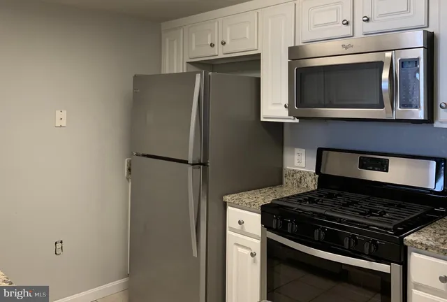 a view of an empty room with a fireplace