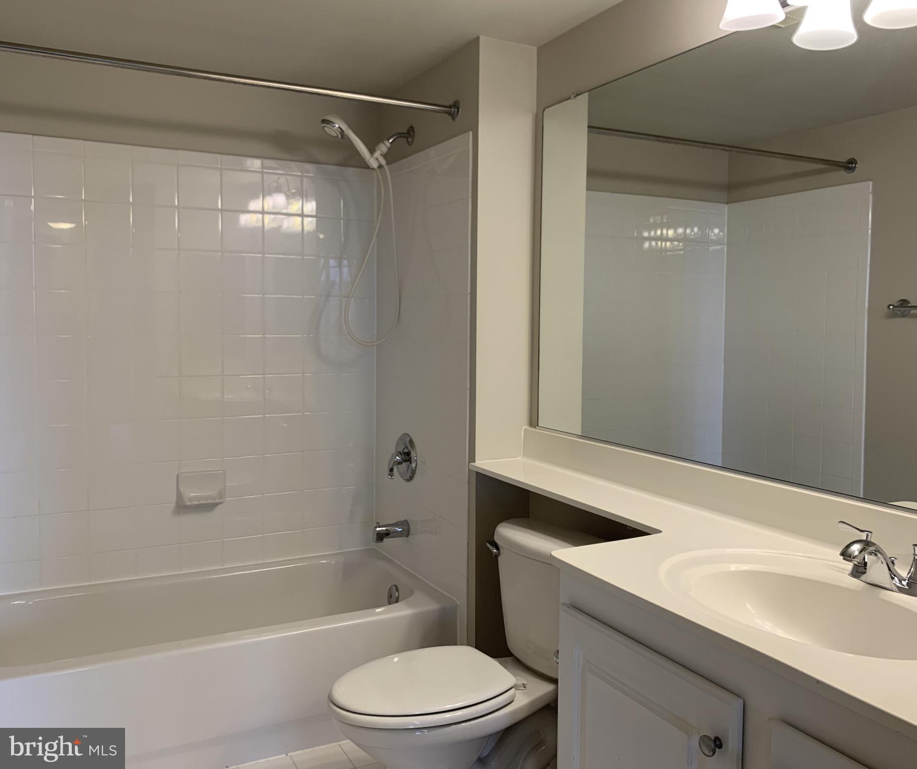 11710 Old Georgetown Road, Unit 1012 North Bethesda, MD 20852 - Photo 5 of 6 a bathroom with a sink mirror toilet and bathtub