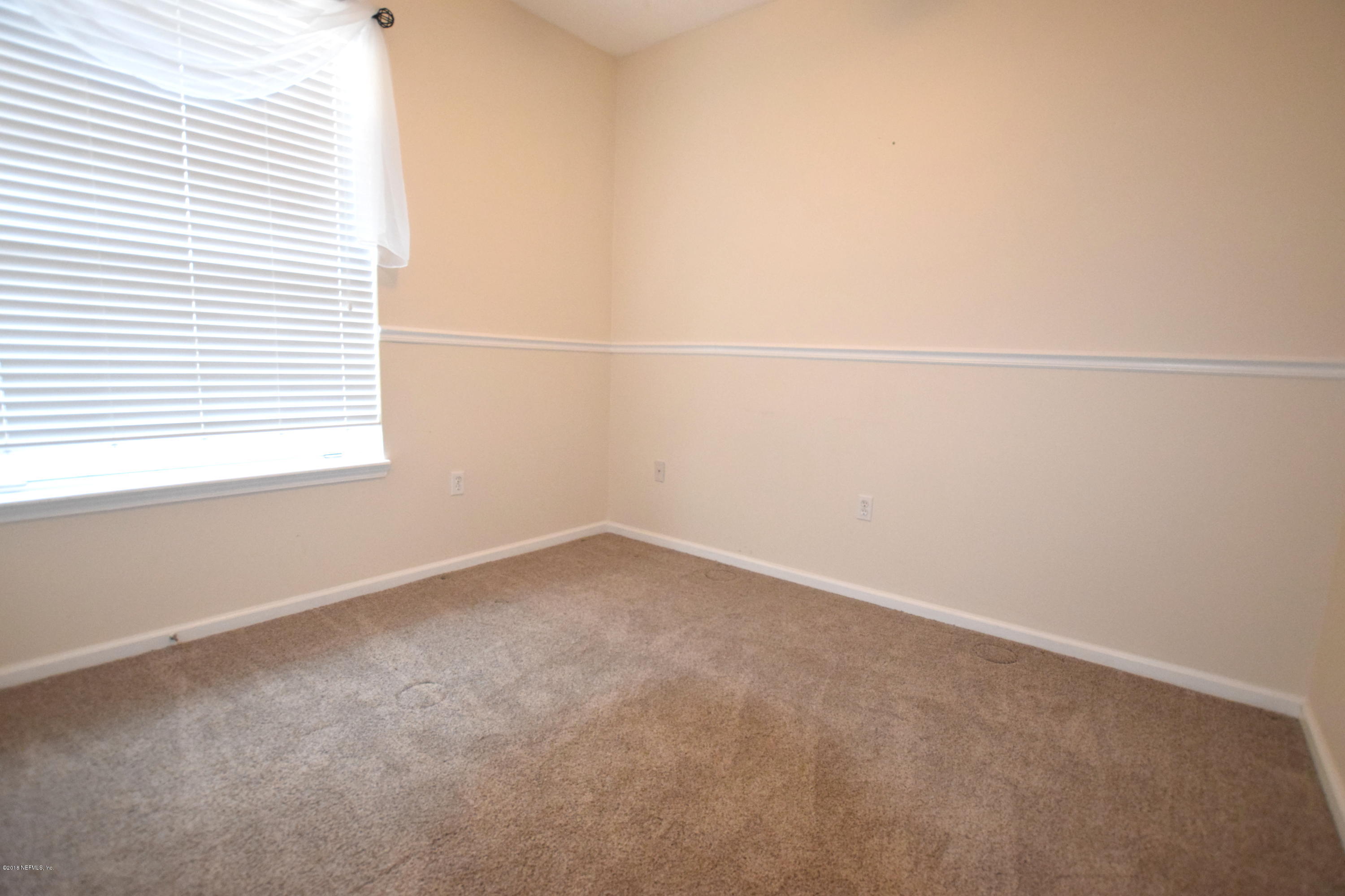 10550 Baymeadows Road, Unit 1016 Jacksonville, FL 32256 - Photo 11 of 17 an empty room with a window