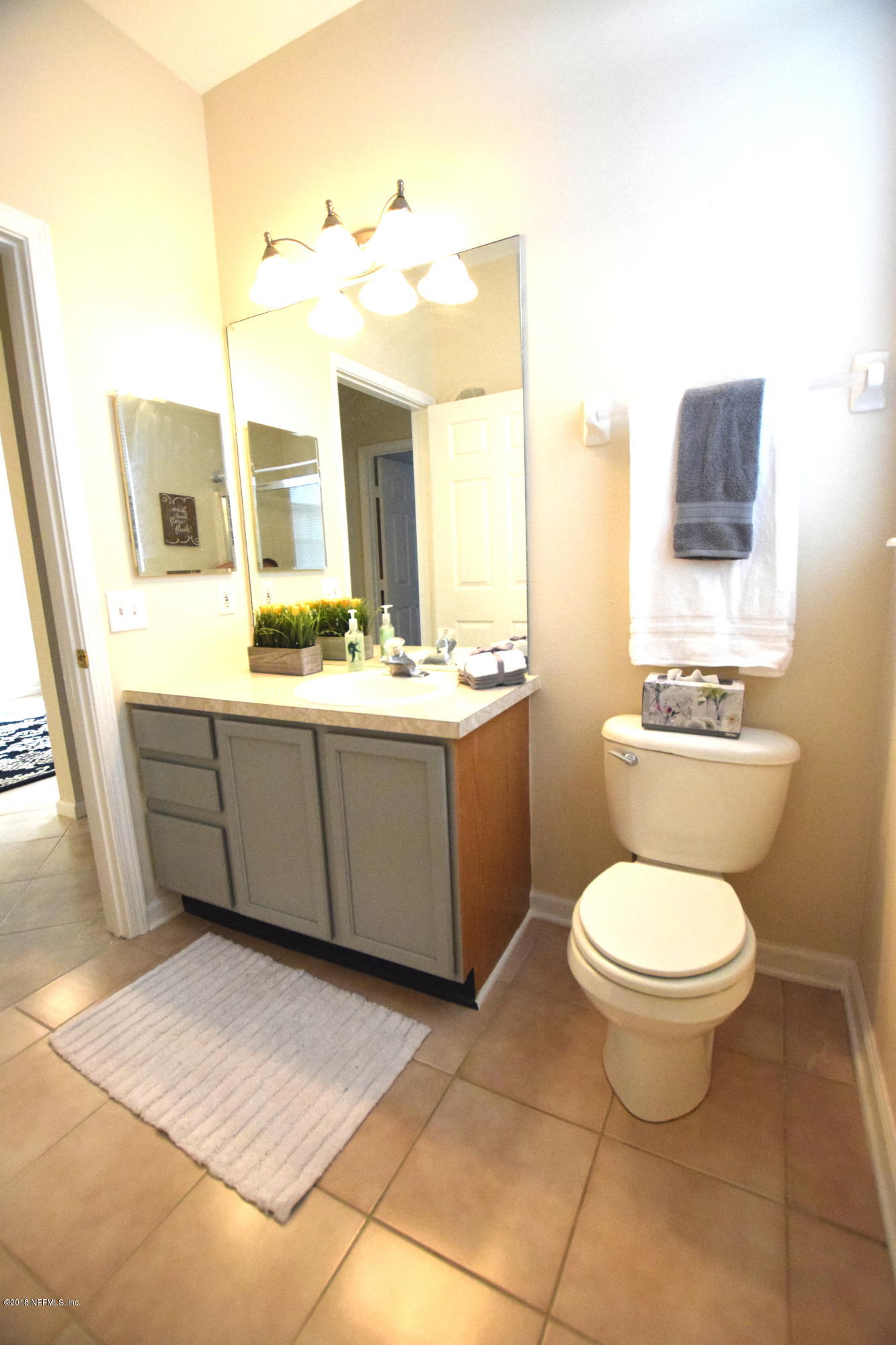 10550 Baymeadows Road, Unit 1016 Jacksonville, FL 32256 - Photo 13 of 17 a bathroom with a toilet sink and mirror