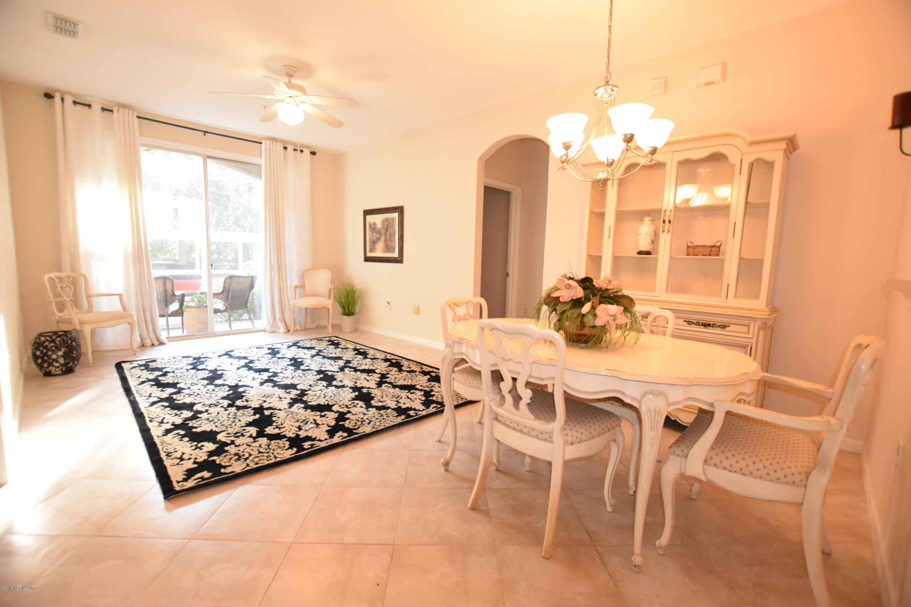 10550 Baymeadows Road, Unit 1016 Jacksonville, FL 32256 - Photo 2 of 17 a living room with dining table and a large window