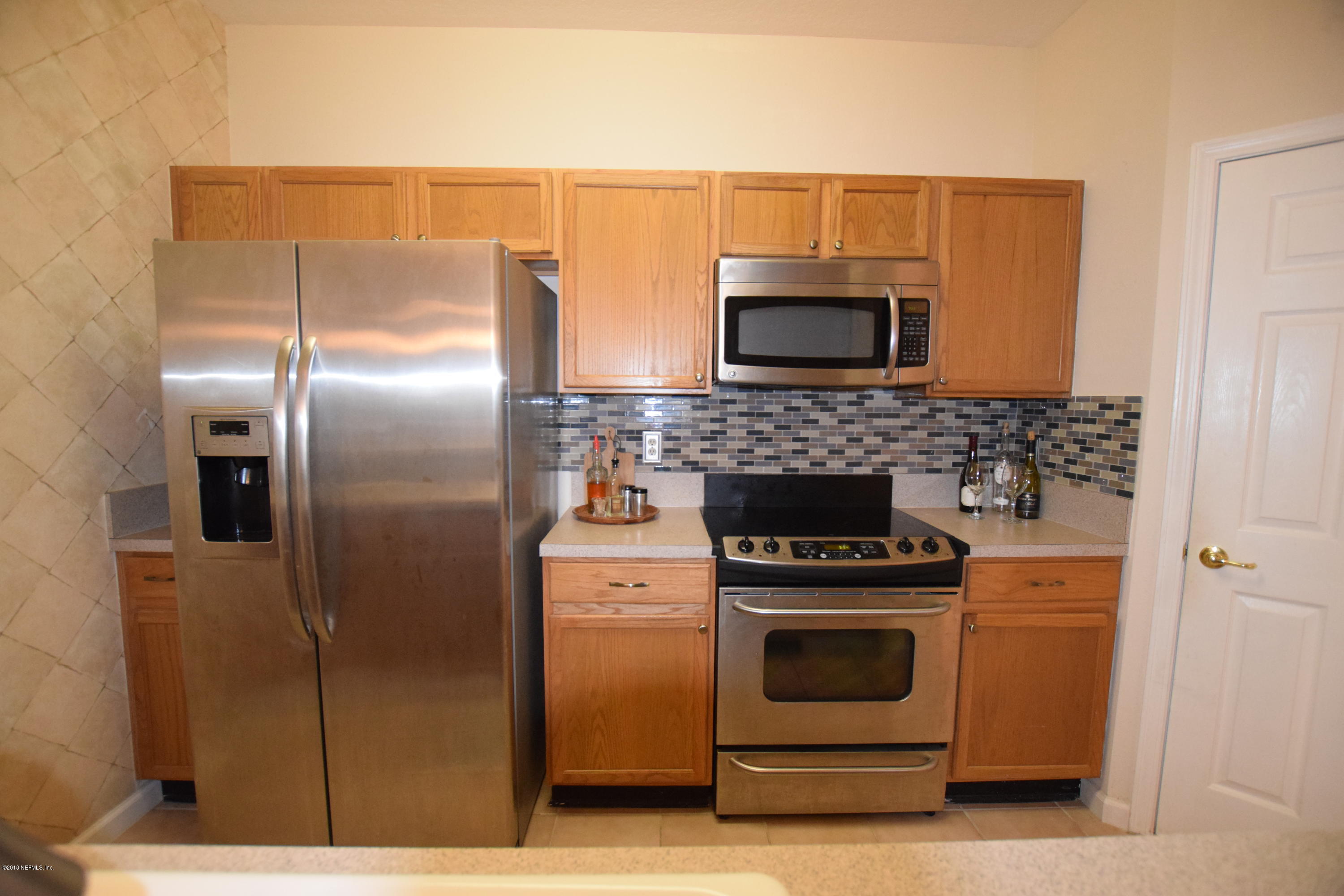 10550 Baymeadows Road, Unit 1016 Jacksonville, FL 32256 - Photo 5 of 17 a kitchen with cabinets and steel stainless steel appliances