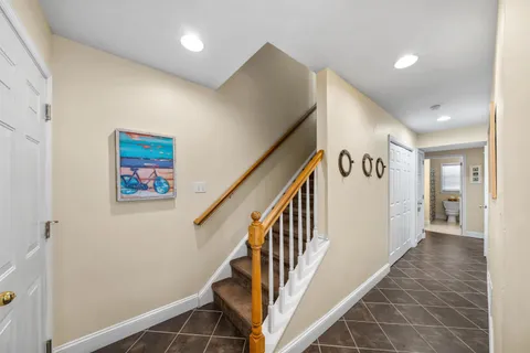a view of a hallway with wooden floor and stairs