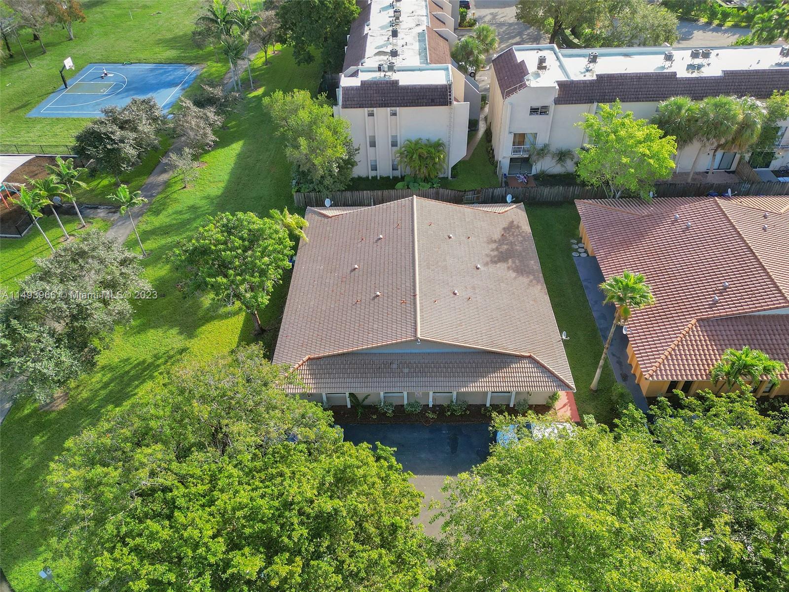an aerial view of a house with garden space and a street view