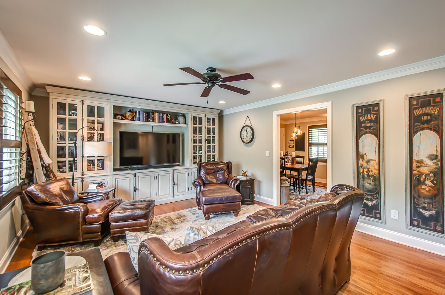 5934 Garrison Road Franklin, TN 37064 - Photo 14 of 39 a living room with furniture floor to ceiling window hardwood floor and a flat screen tv