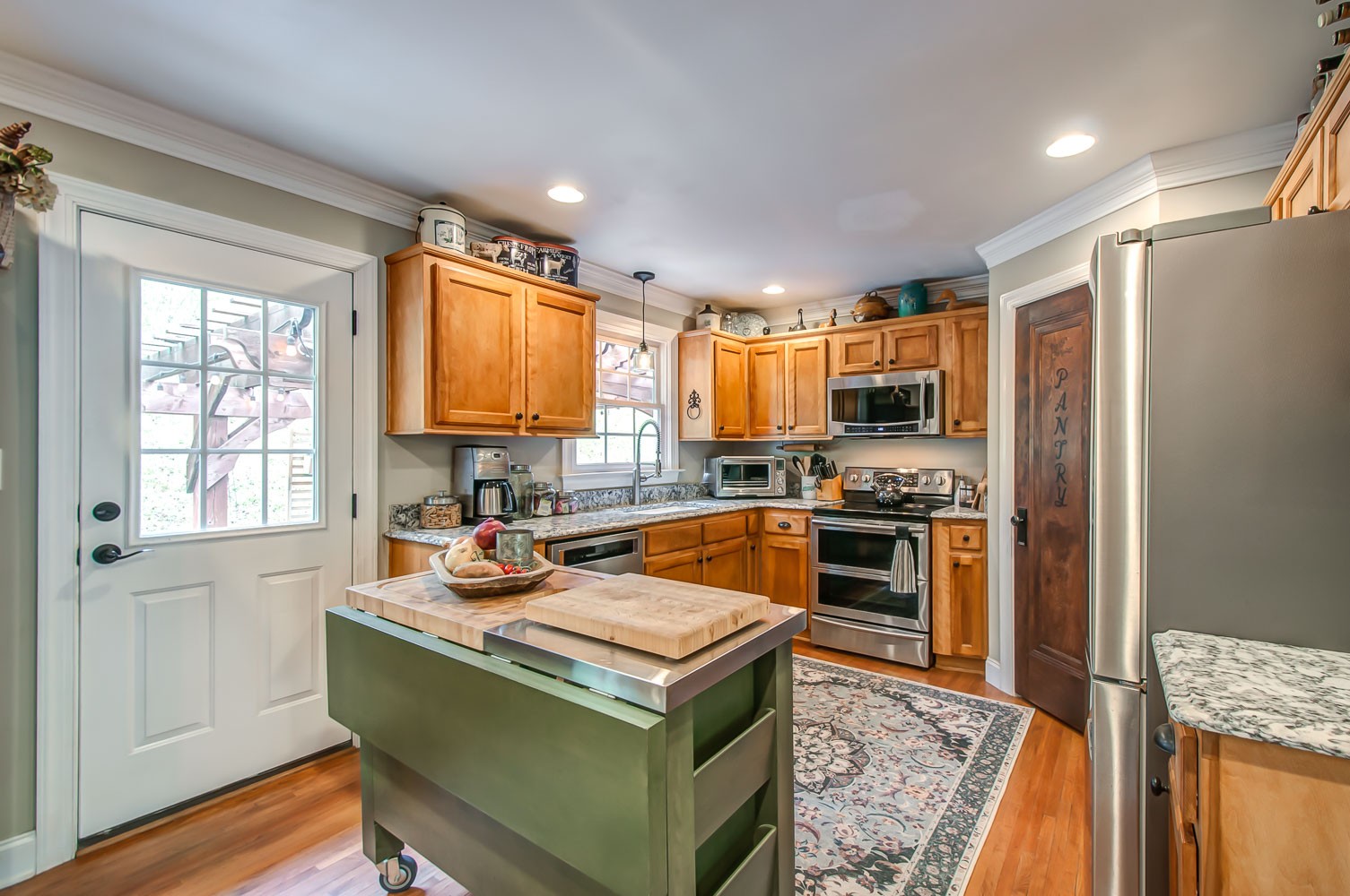 5934 Garrison Road Franklin, TN 37064 - Photo 23 of 39 a kitchen with a stove a sink and a refrigerator